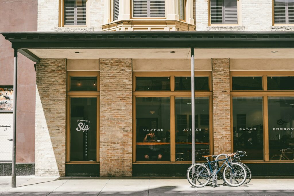 two bicycle parked near brown building