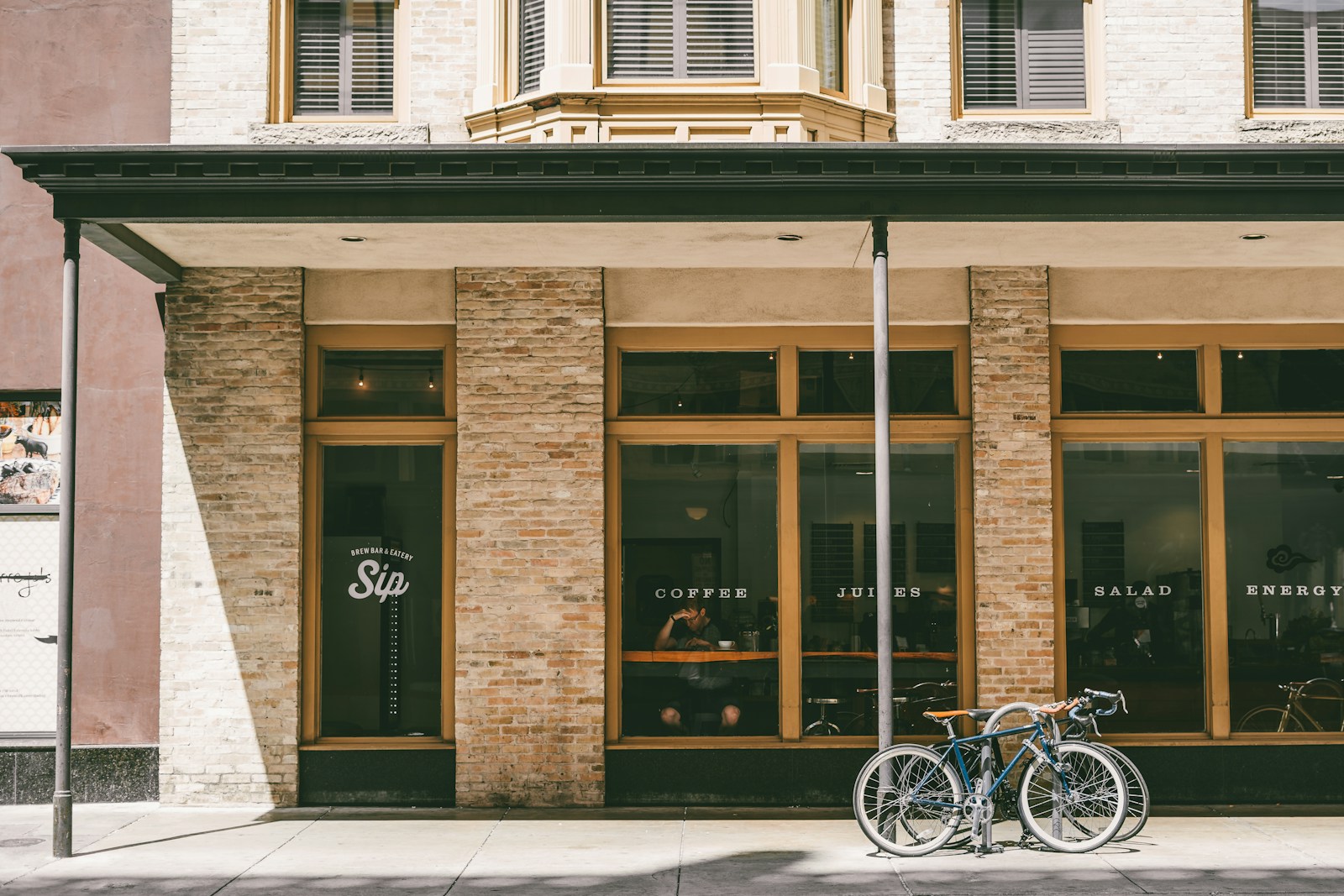 two bicycle parked near brown building